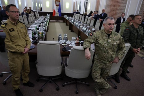 Polish state fire service Cmdr Wojciech Kruczek and Gen Wieslaw Kukula, chief of the general staff of the Polish armed forces, gather at the Chancellery of the prime minister for an extraordinary government meeting, after violations of Polish airspace during a Russian attack on Ukraine.