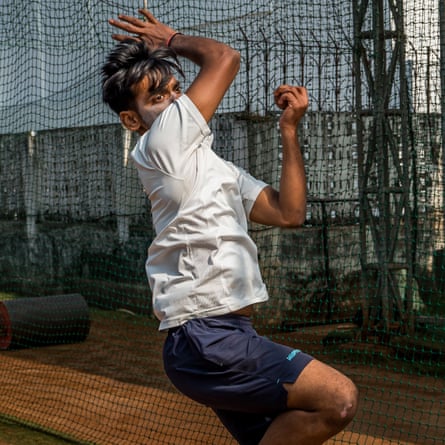 A player wearing sun cream on his face. practises bowling at the Vasoo Paranjape Cricket Academy.