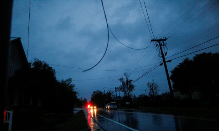 Power lines are seen hanging from a post during the passing of Florence in the town of New Bern.