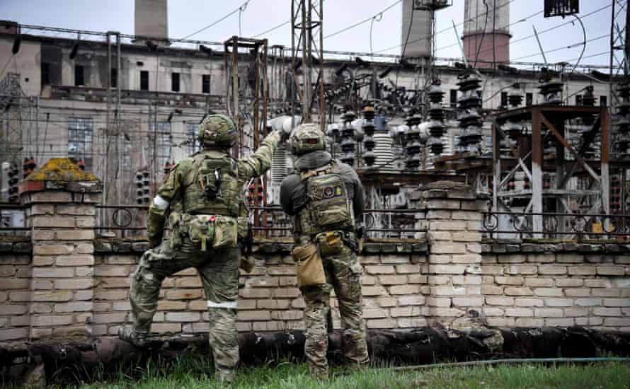 In a picture taken yesterday during a trip organized by the Russian military, Russian soldiers are seen standing guard at the Luhansk power plant in the town of Shchastya.