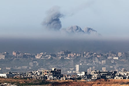 Smoke plumes rising from explosions above destroyed buildings in the northern Gaza Strip seen from Southern Israel, 14 January