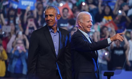 Barack Obama and Joe Biden wave to a crowd of supporters at a rally.