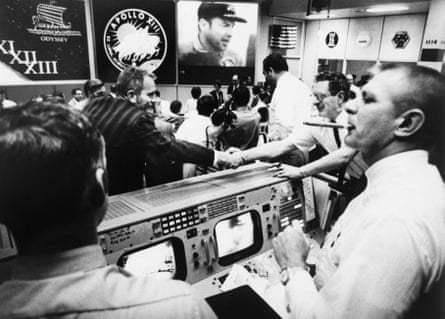 the scene at mission control minutes after the recovery of the apollo 13 crew. flight director gene kranz is on the far right with a cigar in his mouth