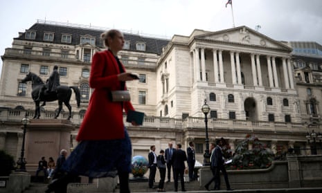 People stand outside the Bank of England in the City of London.