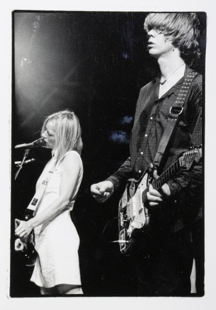Black and white photo of Kim Gordon singing while Thurston Moor plays guitar