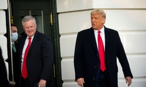 In this file pic from October, 2020, Mark Meadows follows Donald Trump out of the White House on their way to board the Marine One presidential helicopter waiting on the lawn.