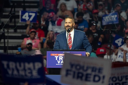people holding signs in front of a man