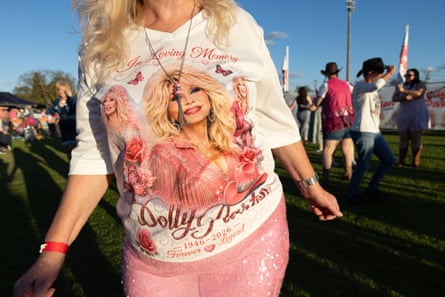 A woman wears pink sequin pants and a dolly parton t-shirt
