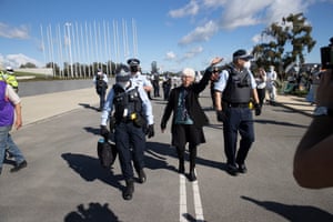 Margaret Clough, surrounded by police, waves to cameras