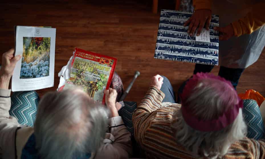Care home residents in London opening gifts sent by their families on Christmas Day 2020.