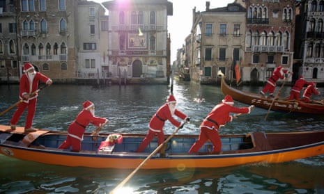 Gondoliers race through Venice’s canals in seasonal attire.