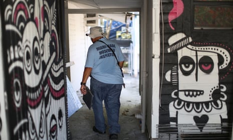 A Miami-Dade County mosquito control worker inspects a property for mosquitos or breeding areas in the Wynwood neighborhood. 