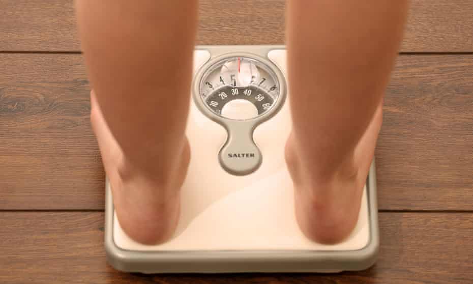 A girl on a set of weighing scales