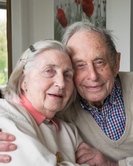 Eric and Eva embrace cheek to cheek, smiling