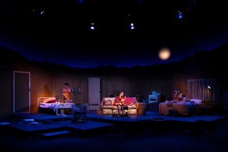 Melodie Reynolds-Diarra, Tyallah Bullock and Roxanne McDonald perform on a dimly lit stage set at night