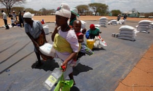 Zimbabweans collect grain distributed by World Food Programme (WFP) on November 25, 2013 in East Mashonaland, Zimbabwe.