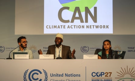 Three people on a panel with ‘CAN Climate Action Network’ sign above