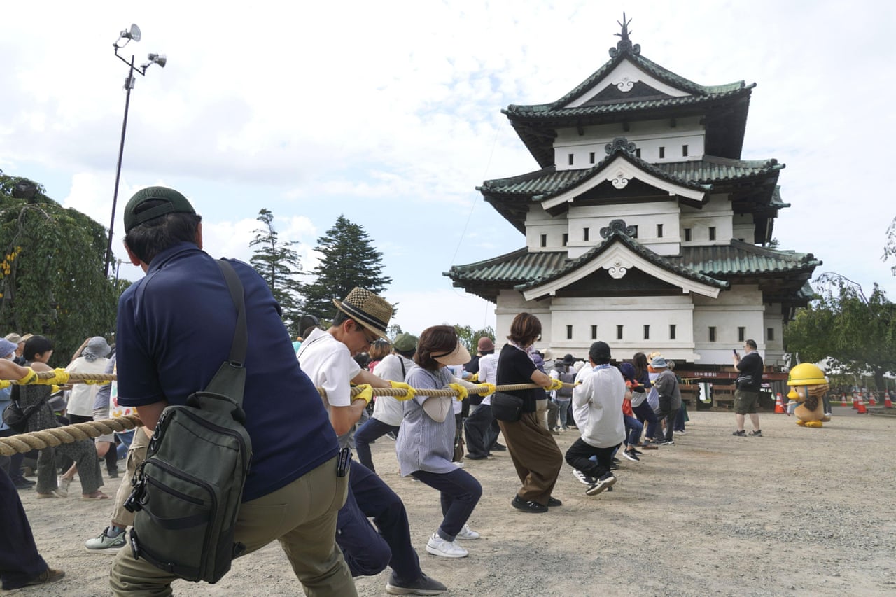 People pull on ropes to move the Hirosaki Castle keep in north-eastern Japan at the weekend