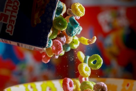 Rainbow coloured cereal being poured into a bowl