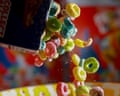 Brightly coloured cereal being poured into a