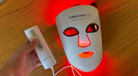 A Currentbody LED mask, backlit with a red glow