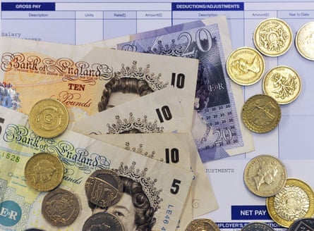 Picture of sterling notes and coins atop a blue payslip