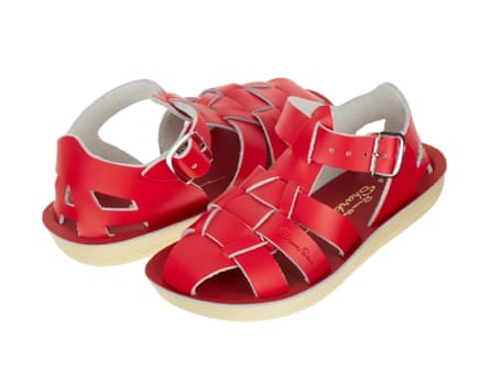A pair of red Salt-Water Shark fisher sandals. They are made of a lattice with a buckle fastened ankle strap.