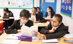 Year 8 students reading A Christmas Carol in an English classroom at Cranford community college in London. 