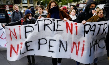 Students hold a banner, reading “Neither homeland, nor boss - Neither Le Pen, nor Macron” during a protest in Paris on Thursday.