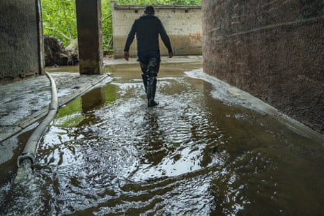 Locals in Kherson are pumping water out of their homes.