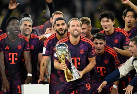 Harry Kane holds the trophy after Bayern win the Supercup against Dortmund.