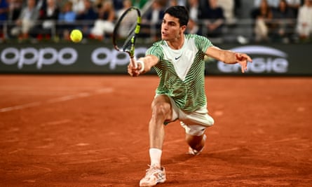 Carlos Alcaraz plays a backhand against Stefanos Tsitsipas in their French Open quarter-final