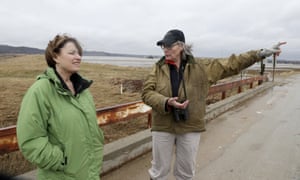 Resident Fran Karr, right, points out to Amy Klobuchar the flooded areas around her home in Pacific Junction, Iowa, in March. ‘She’s your classic retail politician,’ one analyst observed.