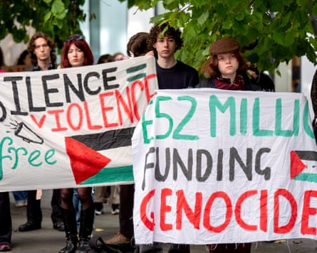 A group of young protesters holding pro-Palestine banners.