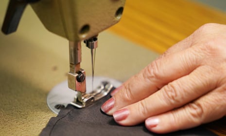 A worker uses a sewing machine.