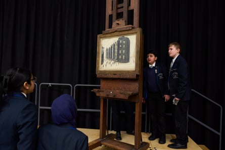 Pupils at the Lowry Academy in Salford stood next to ‘Dwelling, Ordsall Lane, Salford’ which is on an easel