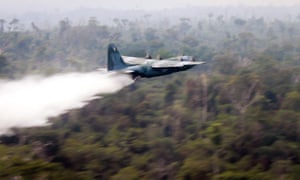 A Hercules C-130 plane dropping water to fight fires in the state of Rondonia, Brazil.