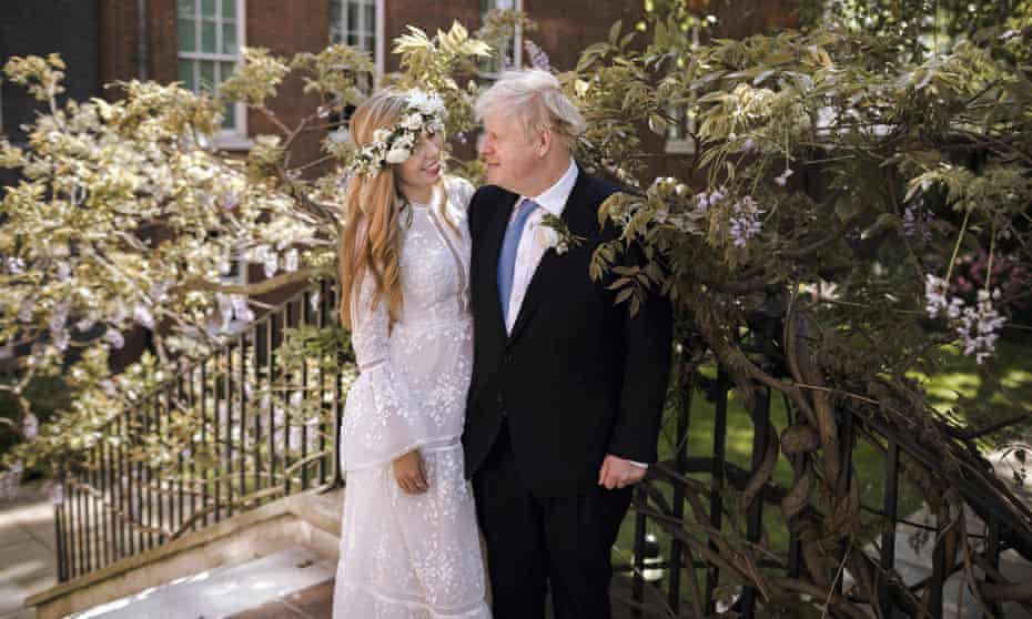 Britain's Prime Minister Boris Johnson and Carrie Johnson pose together for a photo in the garden of 10 Downing Street after their wedding