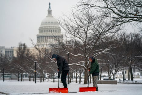 Workers shoveling snow near the US Capitol in Washington, DC, earlier today.