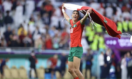 Jawad El Yamiq with a half-and-half Morocco-Qatar flag.