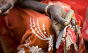 A cutter holding the tool she used to perform the procedure at a community meeting in Afar, Ethiopia.