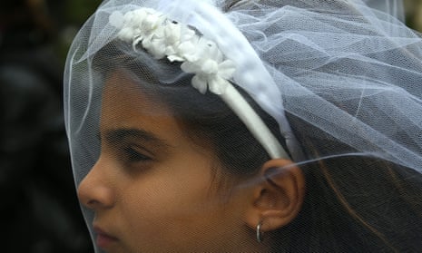 A young actress plays the role of Giorgia, 10, forced to marry Paolo, 47, during an event organised by Amnesty International to denounce child marriage.