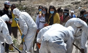 Workers bury an alleged victim of Covid-19 at the Municipal Pantheon of Valle de Chalco, State of Mexico on 4 June 2020.