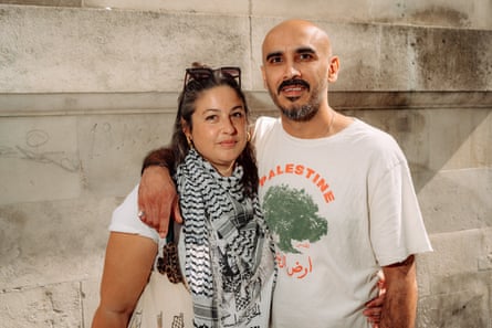 a couple, he in Palestine t-shirt, she in a keffiyah