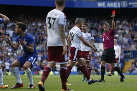 Craig Pawson shows the red card to a disbelieving Cesc Fabregas.