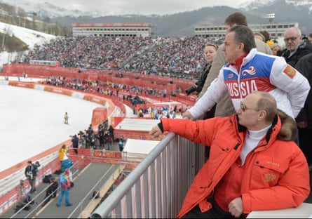 Vladimir Putin watches a downhill ski competition at the 2014 Winter Paralympics in Sochi, Russia.