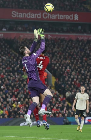 Manchester United’s David de Gea jumps with Liverpool’s Virgil van Dijk.