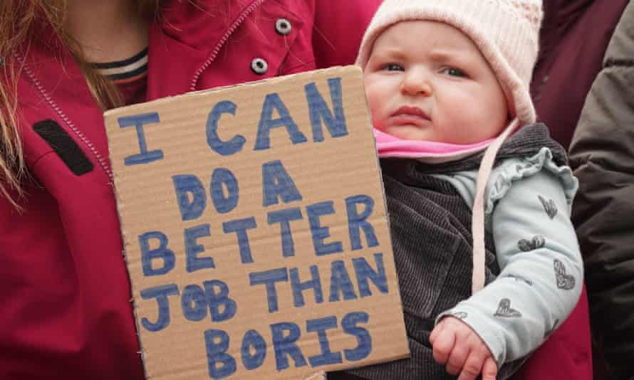 A placard held beside a baby reads: “I can do a better job than Boris.”