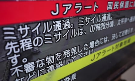 A TV shows J-Alert or National Early Warning System to the Japanese residents. The words read ‘Missile passed. Missile passed.’