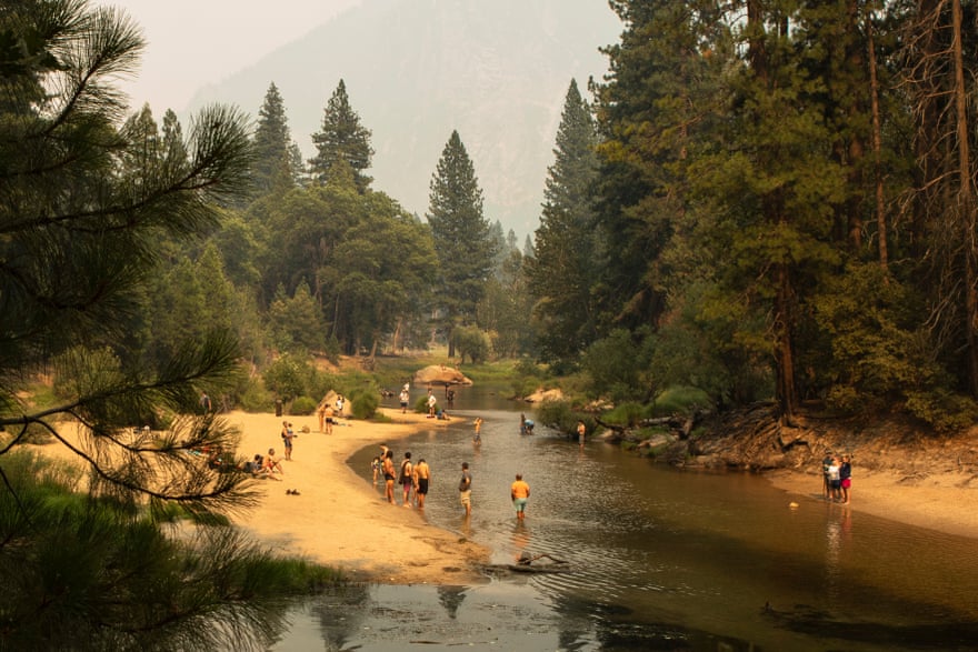 Swimmers enjoy the water despite the air quality.